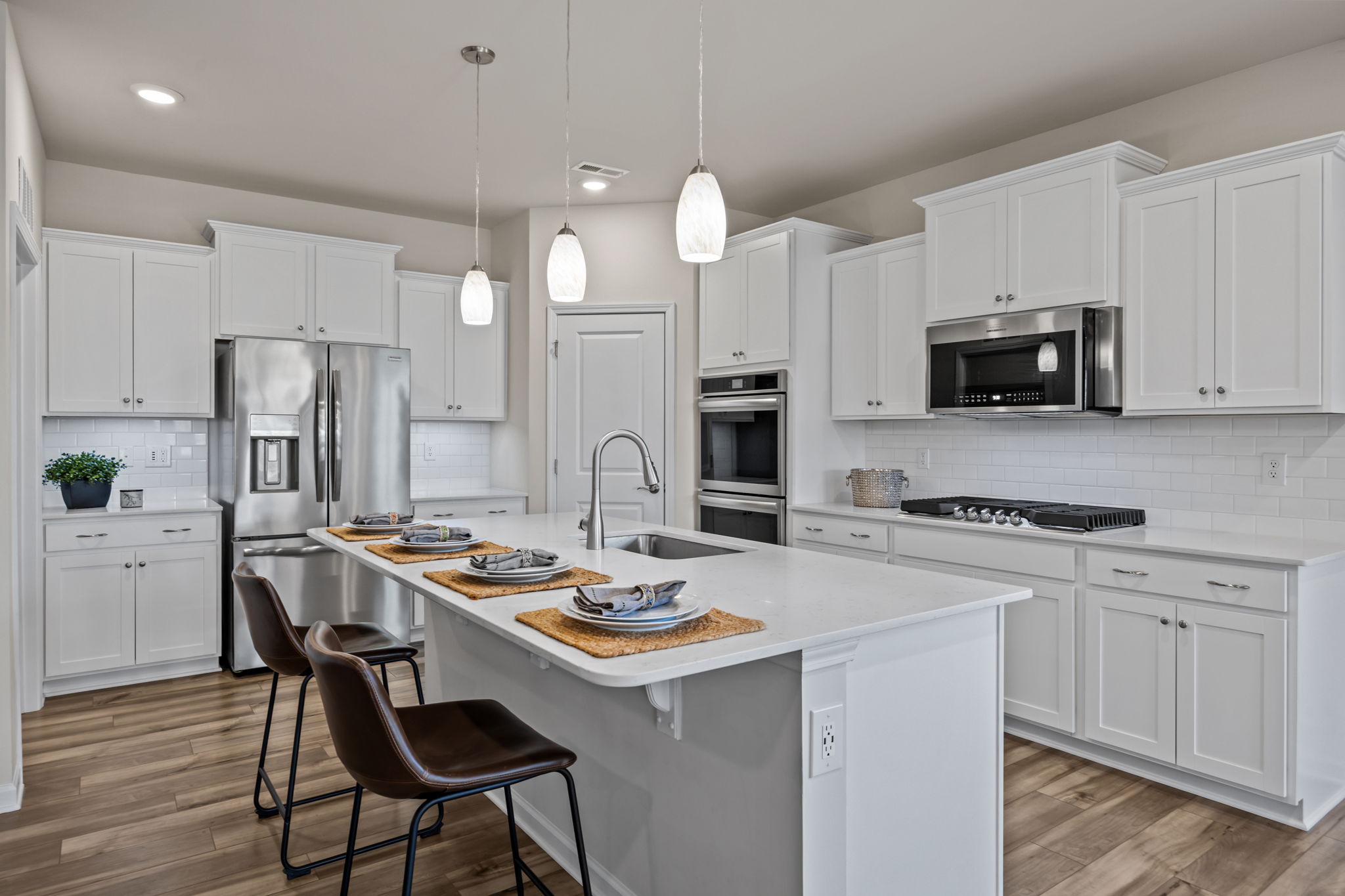 Total package! Tiled backdrops, tons of cabinet space, top of the line appliances, receptacles at convenient locations, AND special phone charging area.  Full corner pantry!