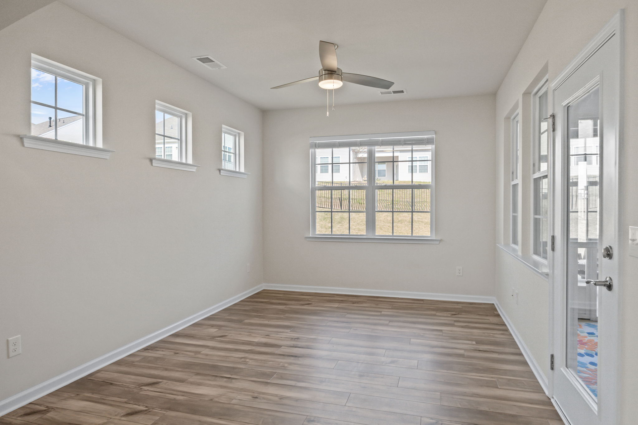 Through the arched entry -- you decide how you wish to use this! An intimate sitting area or dining room?  The glass door leads directly to your outside haven -- a large fully screened covered porch room!