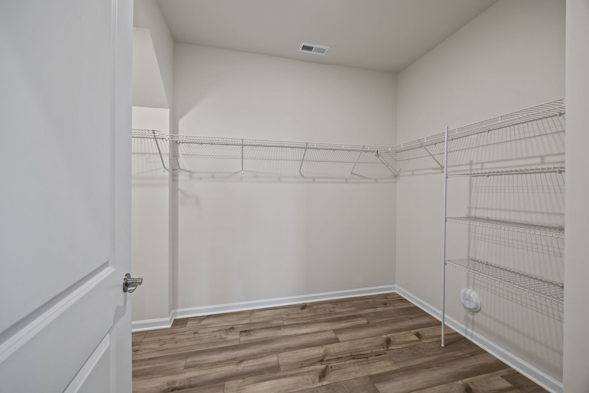 PRIMARY CLOSET - Oh my goodness! Enjoy LVP flooring and loads of space! Wonderful!