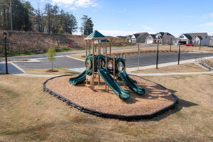 Playground sits side by side with pool and community center.