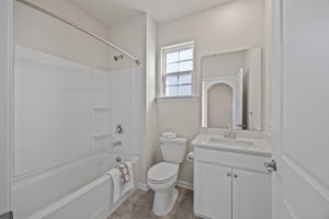Light-filled Full Bath has arched doorway offset entry for privacy and is located next of Office/Bedroom #1.