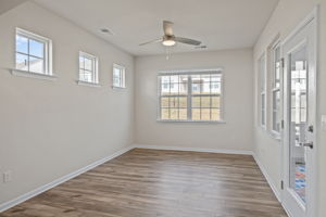Through the arched entry -- you decide how you wish to use this! An intimate sitting area or dining room?  The glass door leads directly to your outside haven -- a large fully screened covered porch room!