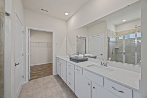 PRIMARY ensuite full bath with long quartz countertop featuring popular squared sinks and loads of room.  Doored toilet facility, tiled floors and ample sized shower.  Expansive closet!   Enjoy!