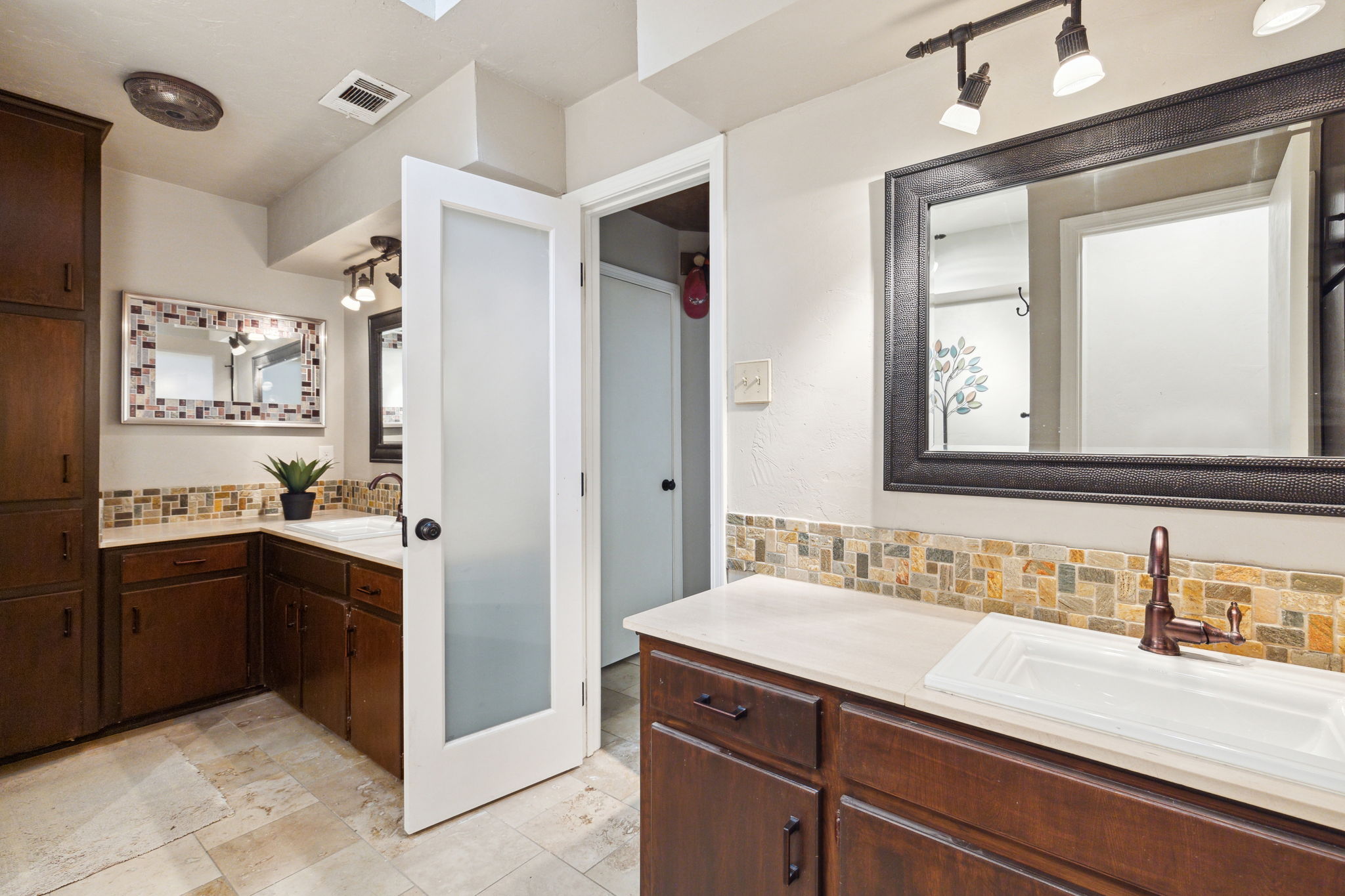 Dual Sinks of Primary Bathroom of Larger Unit