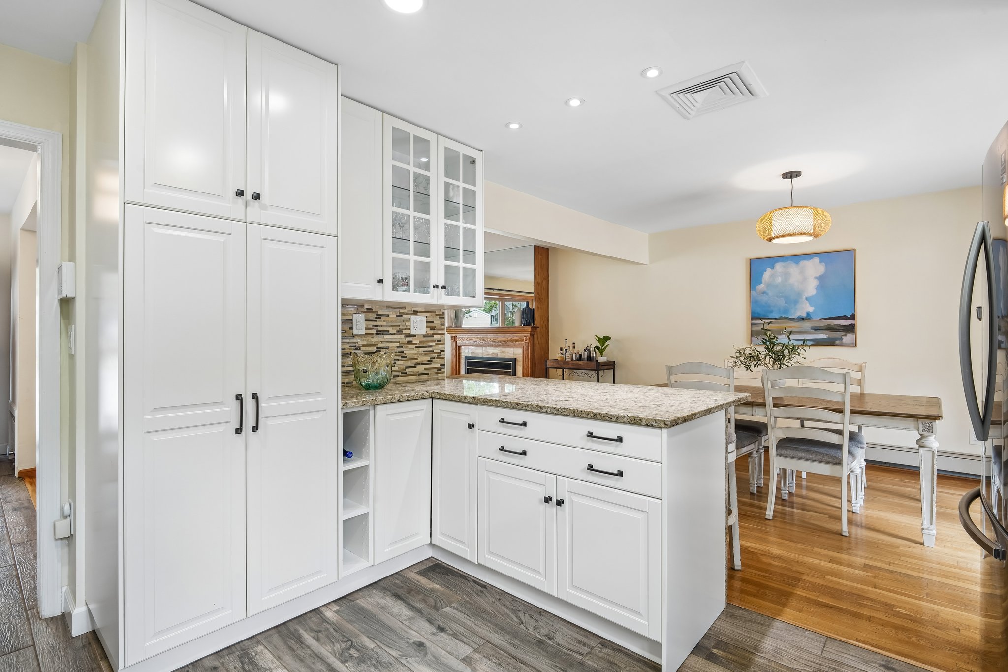 Custom white soft-close cabinetry with pantry closet