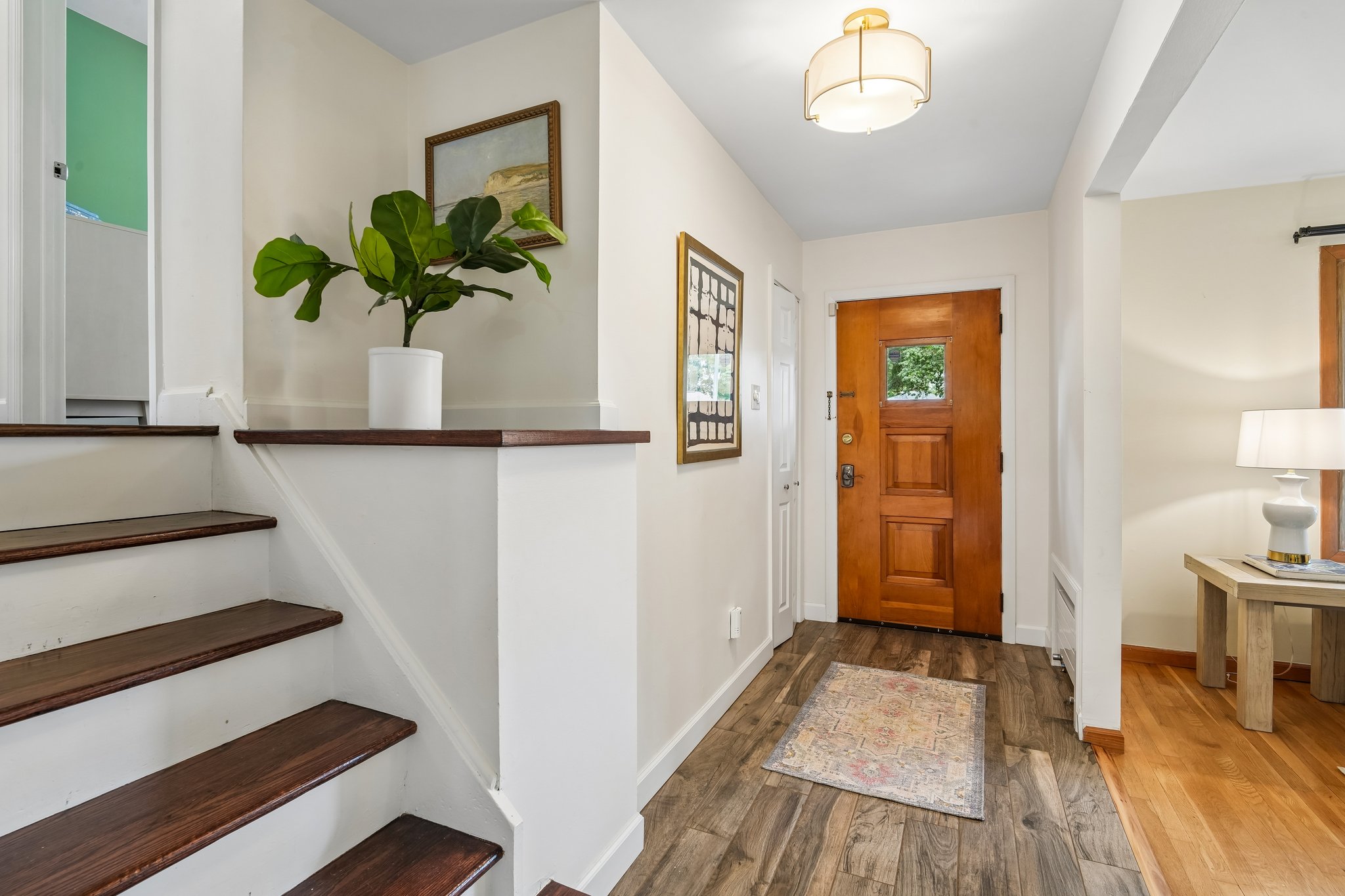Welcoming Foyer leads to Living Room and stairs to Second Floor