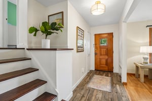 Welcoming Foyer leads to Living Room and stairs to Second Floor