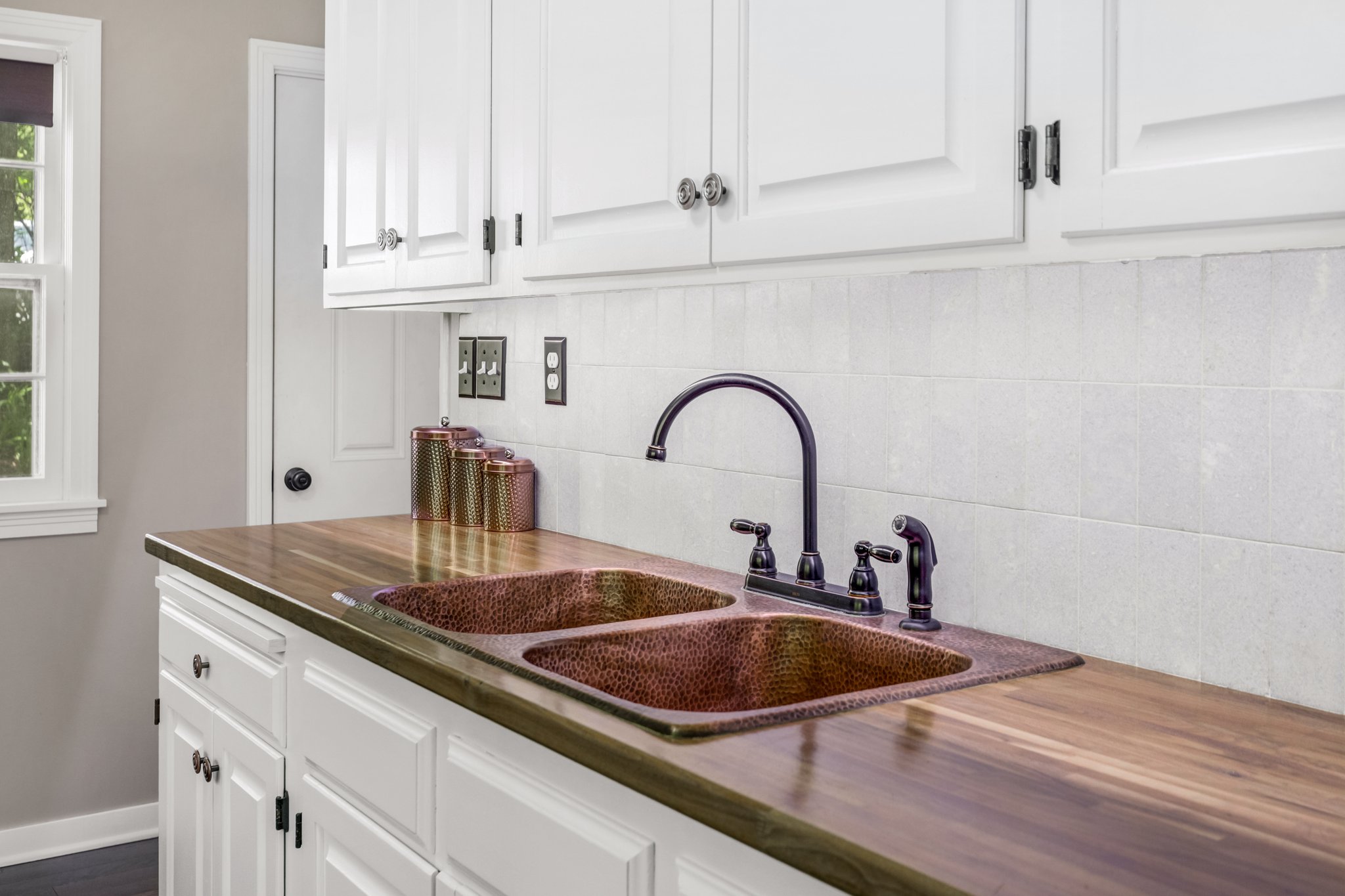 Kitchen - Separate entry; Walnut countertop with copper sink