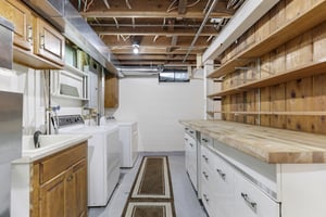 Lower Level Laundry w/ cabinets and shelving