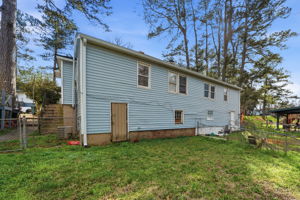 View of back yard.  That door leads to crawl space