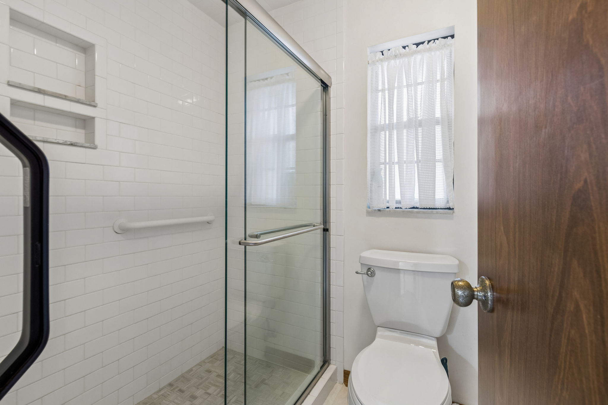 Tiled shower in primary bathroom