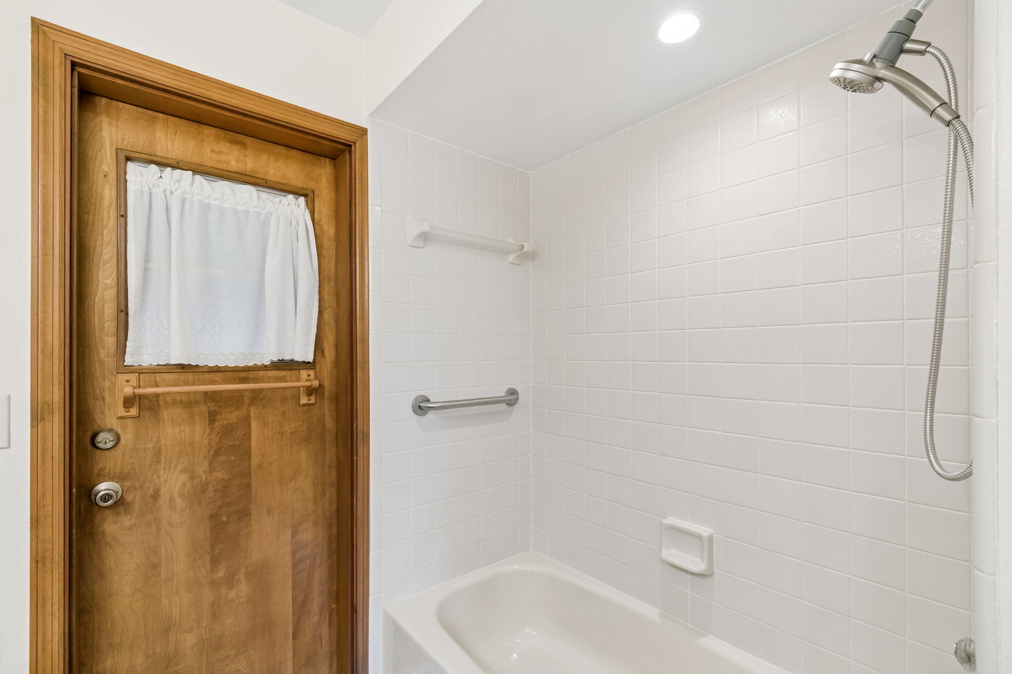 Tiled shower with tub in bathroom 2