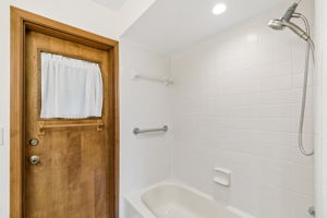 Tiled shower with tub in bathroom 2