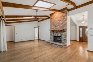 Family room has skylights and double sided fireplace