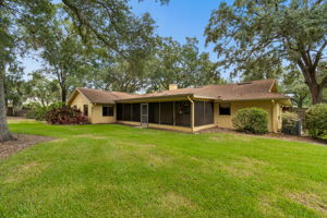 Large screened patio opens to backyard