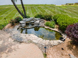 Waterfall/pond and brick paver sitting area view