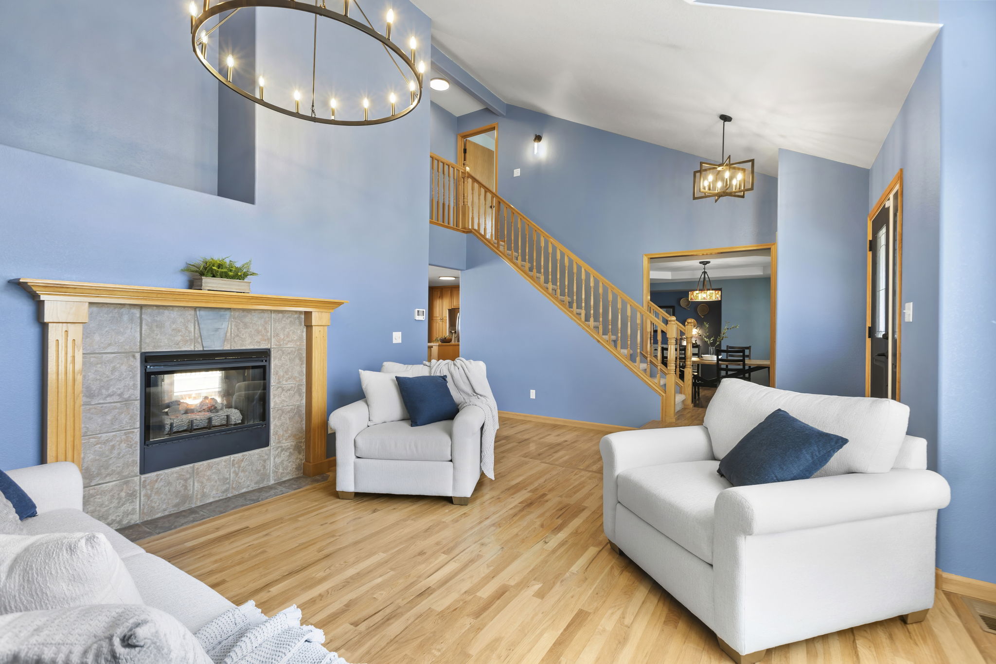 Cozy living room with double sided fireplace opens up to the rest of the home - the floor plan flows so well