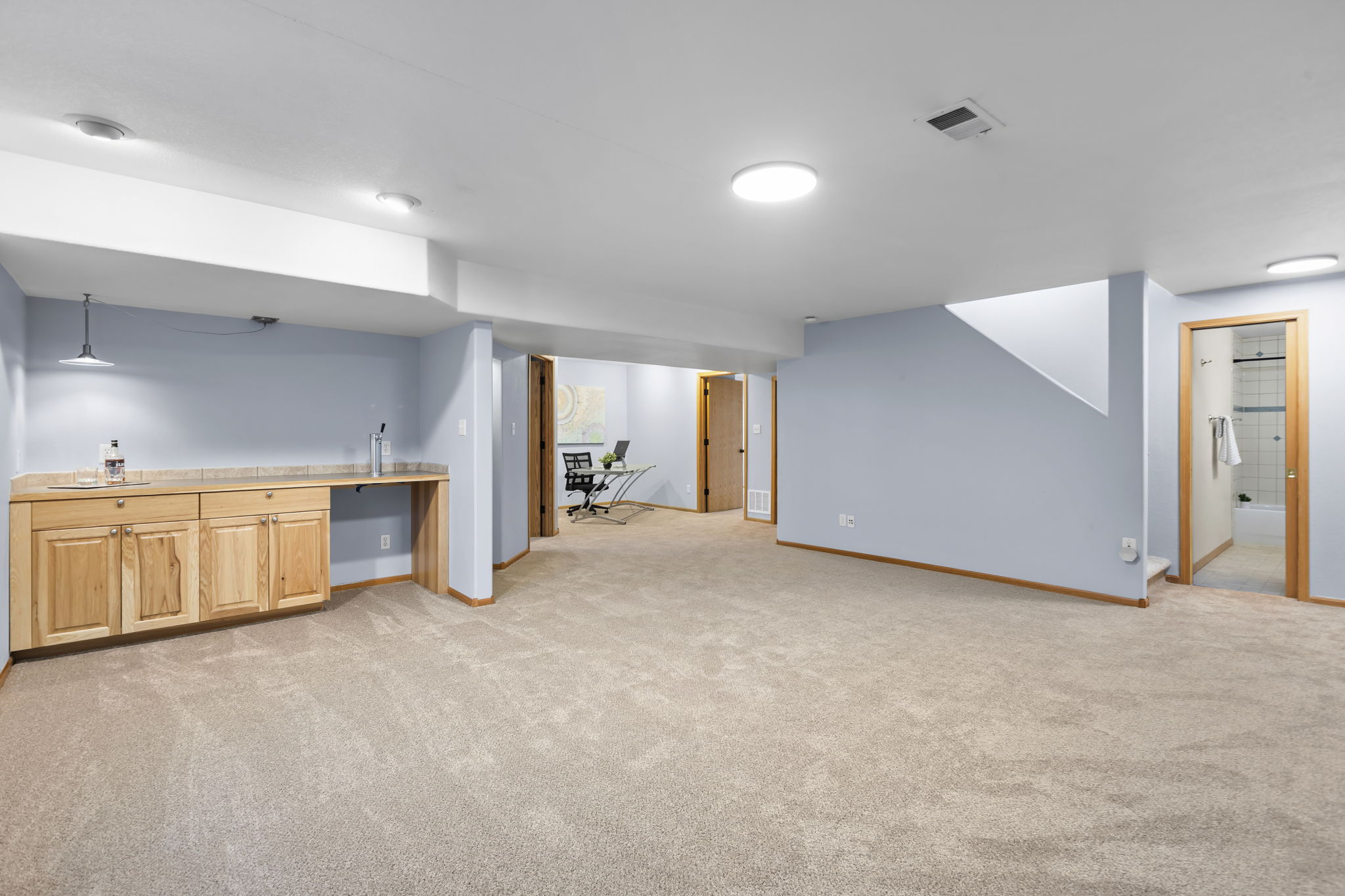 Basement recreation room, wet bar, two bedrooms, full bathroom, and multiple storage areas. Brand new carpet and recently painted