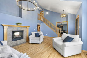Cozy living room with double sided fireplace opens up to the rest of the home - the floor plan flows so well