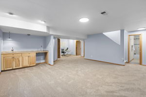 Basement recreation room, wet bar, two bedrooms, full bathroom, and multiple storage areas. Brand new carpet and recently painted