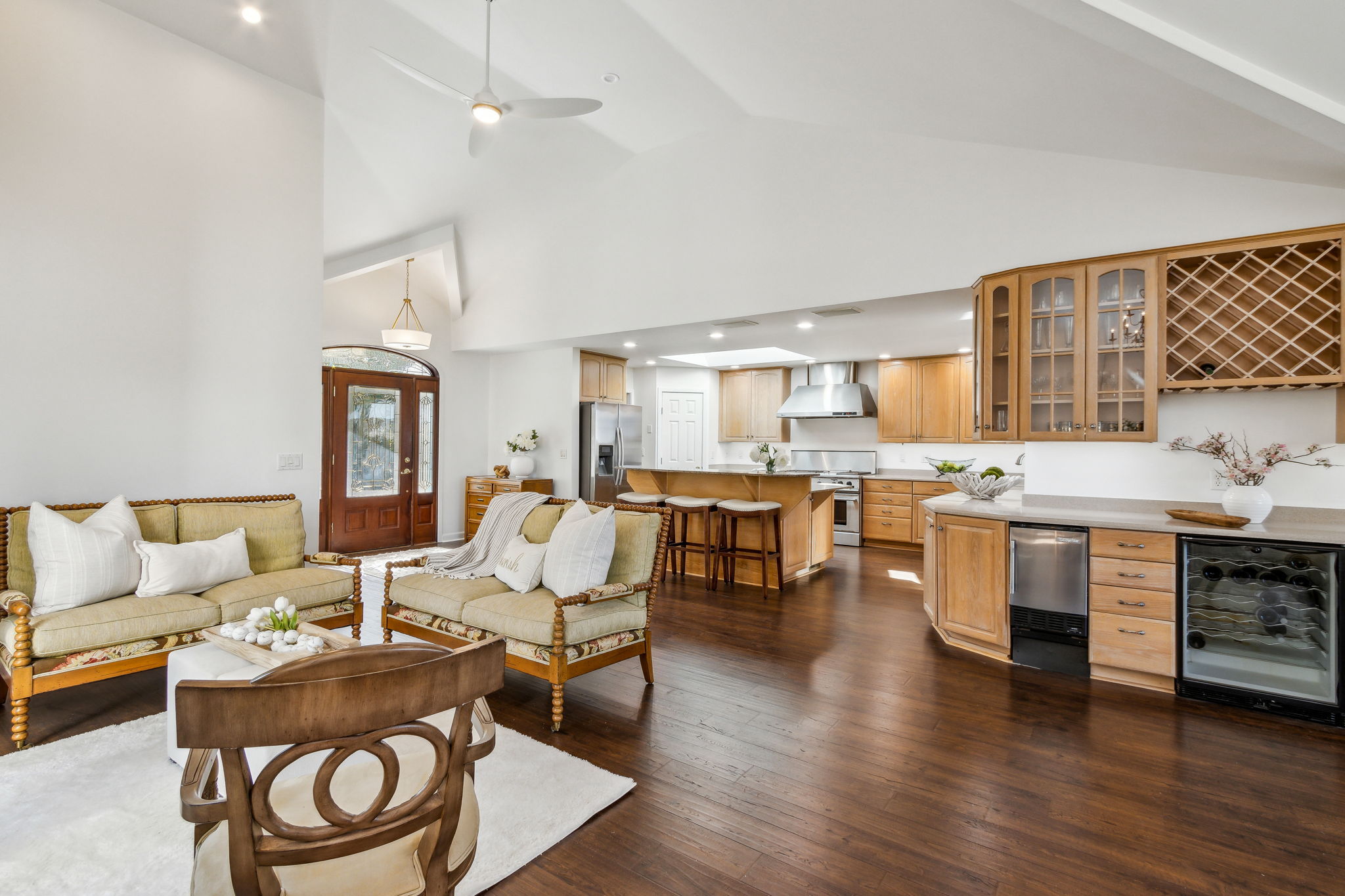 Mahogany-hued wood plank flooring beautifully contrasts with the fresh white paint scheme.