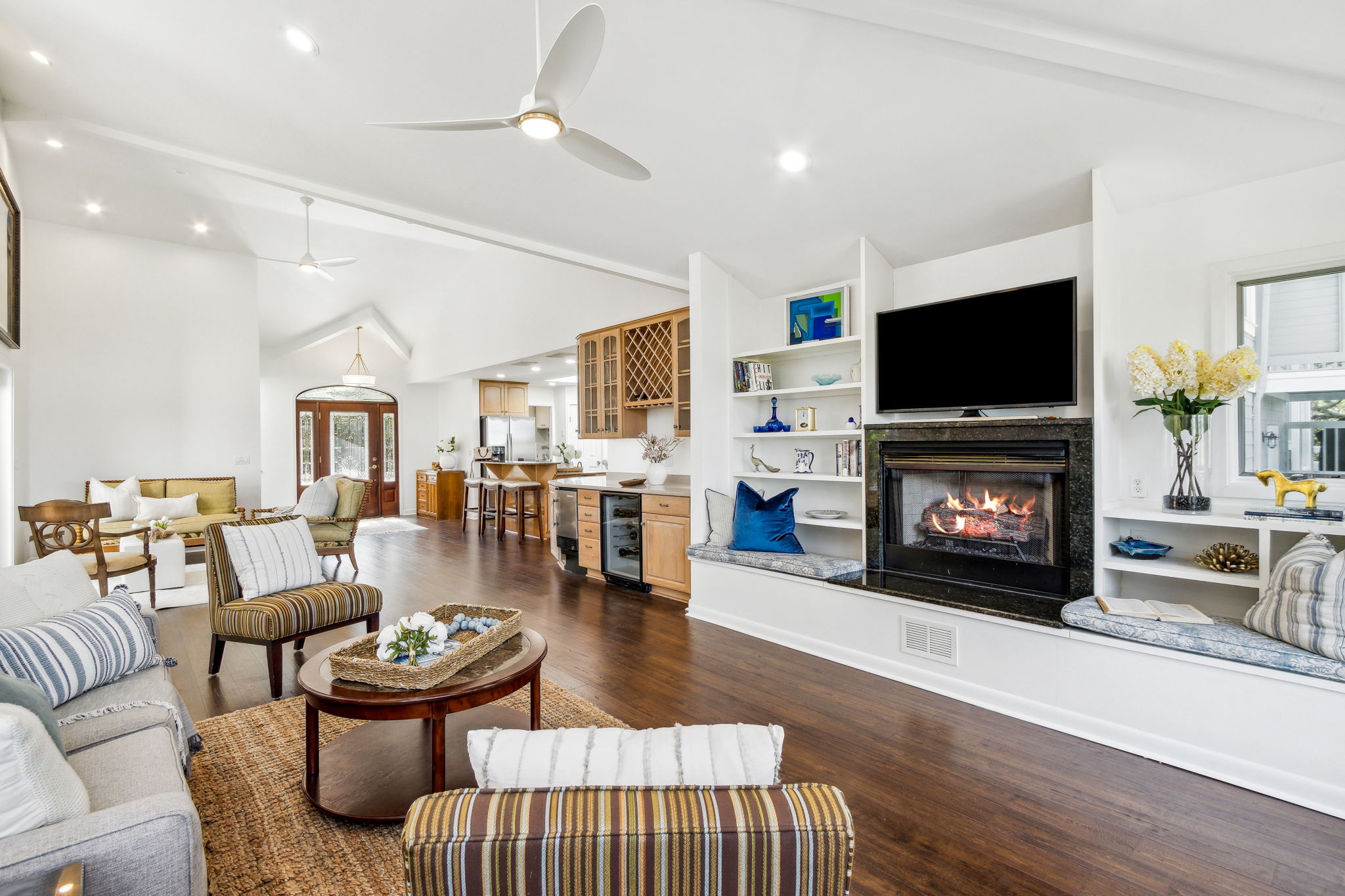 The family room features custom-built shelving and a warm gas fireplace ...