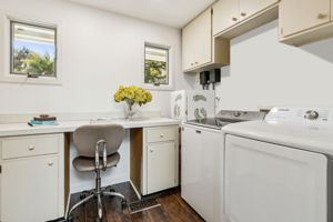 Off the kitchen is a large utility room with a work space, 2nd fridge,  and additional storage.