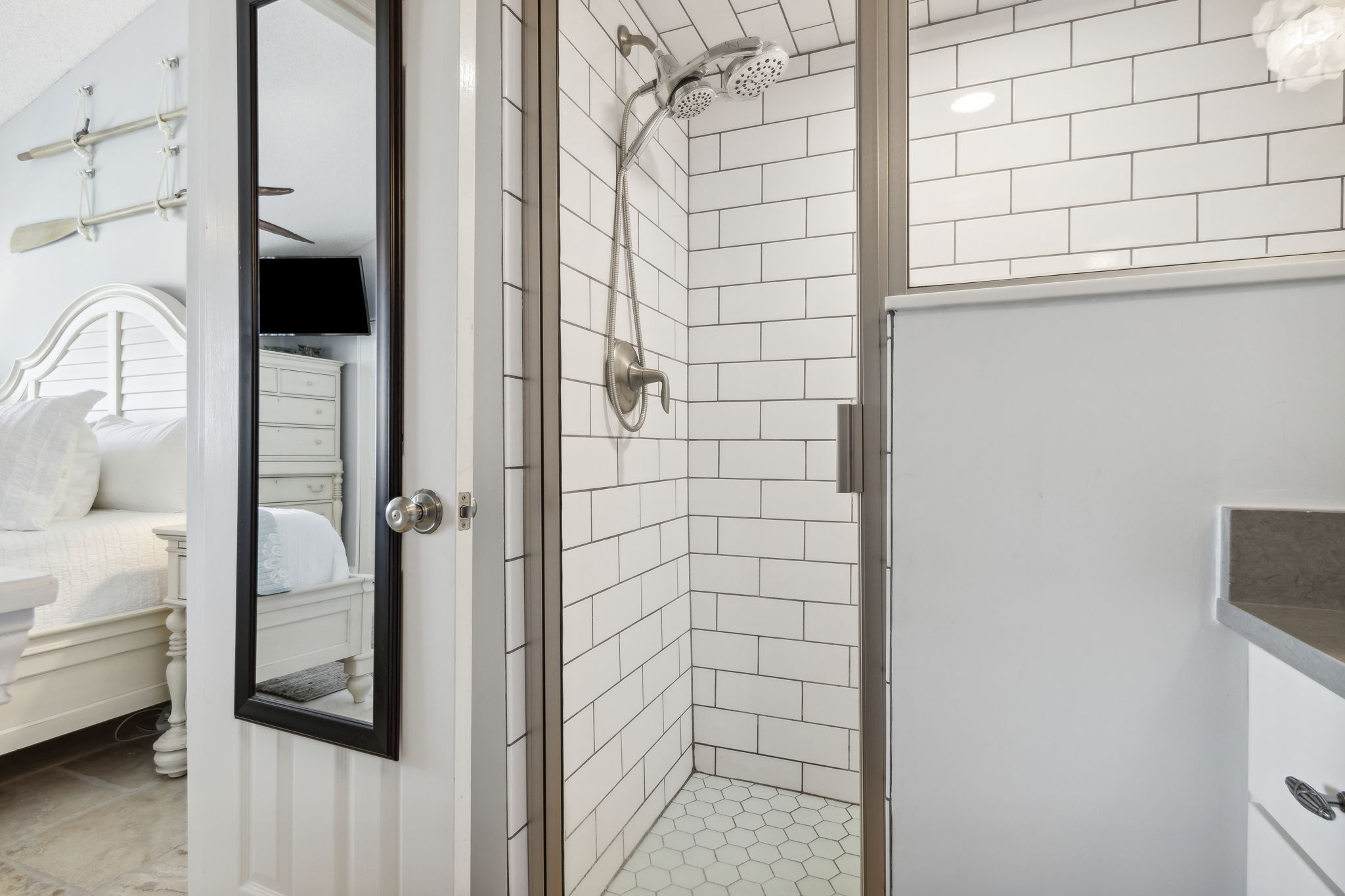 ... and an elegant shower with floor-to-ceiling subway tile.