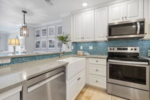 The kitchen boasts stainless steel appliances  ...