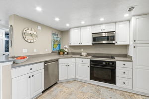 The kitchen remodel was completed in 2023, including quartz counters and new white cabinetry with beadboard accents ......