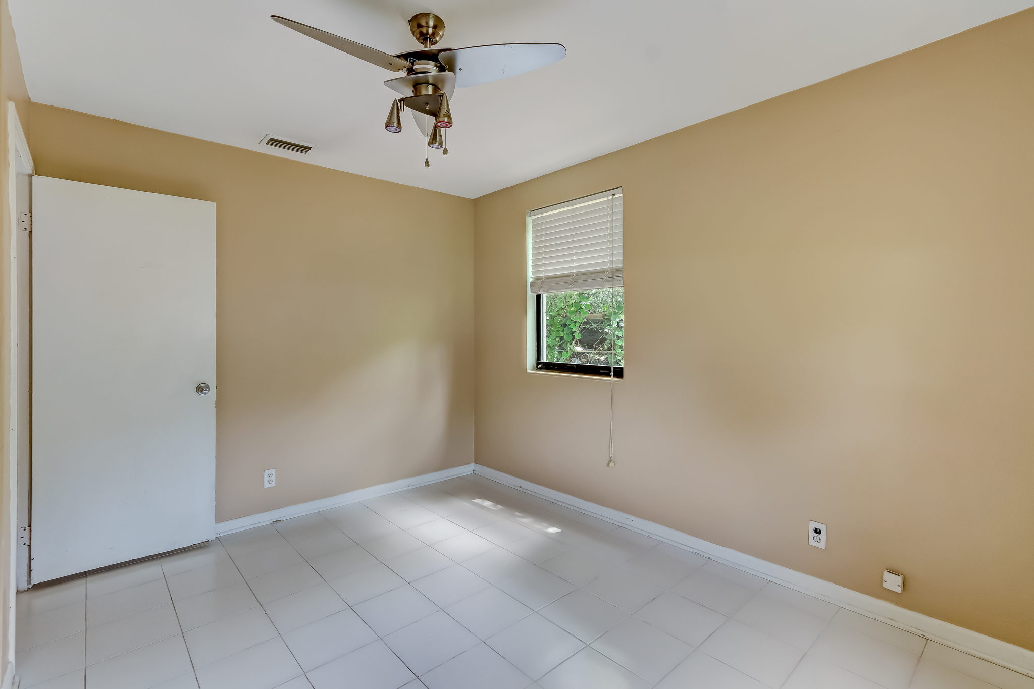 Guest bedroom 3 with ceiling fan and abundant natural light