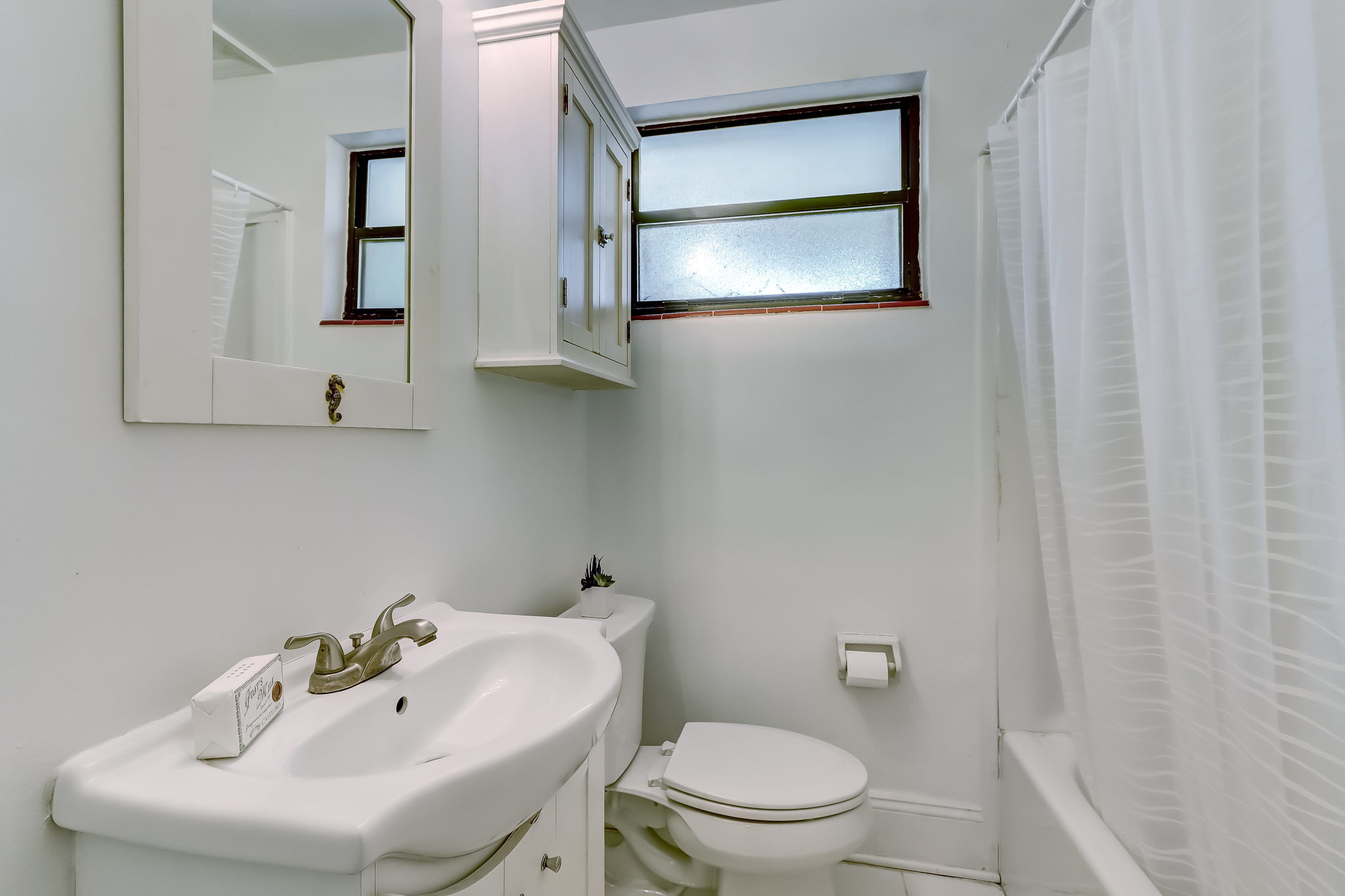 A full bath with tub, shower and vanity