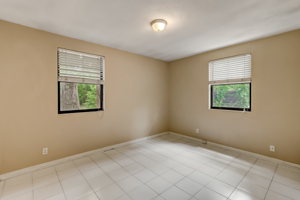 Master bedroom faces beautiful oaks in back yard