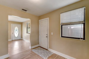 Side door provides covered access to carport and utility/laundry