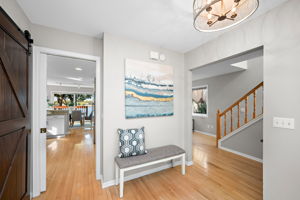 Inviting foyer with hardwood floors and new front door