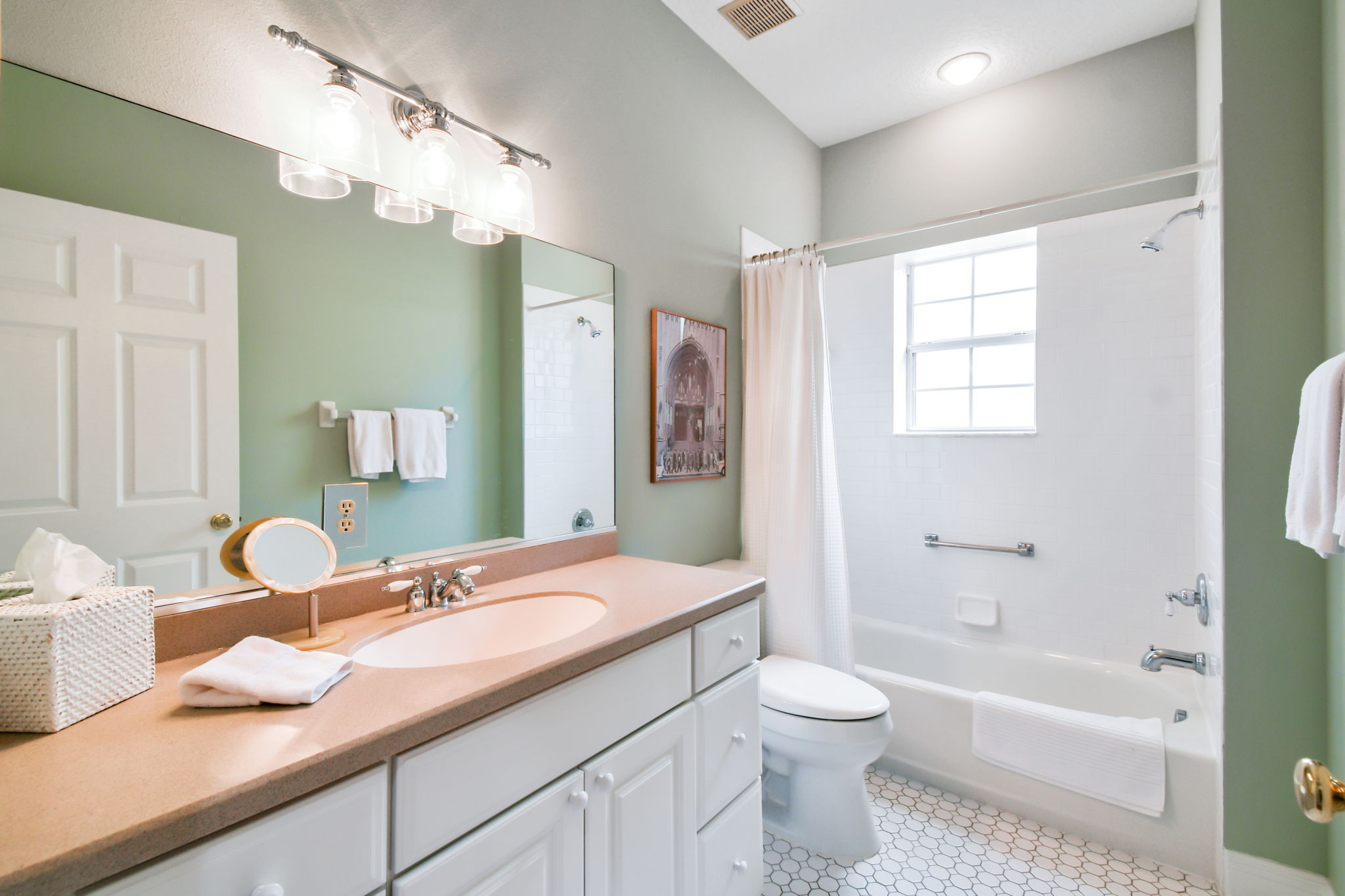 Guest bathroom tub and tiled shower