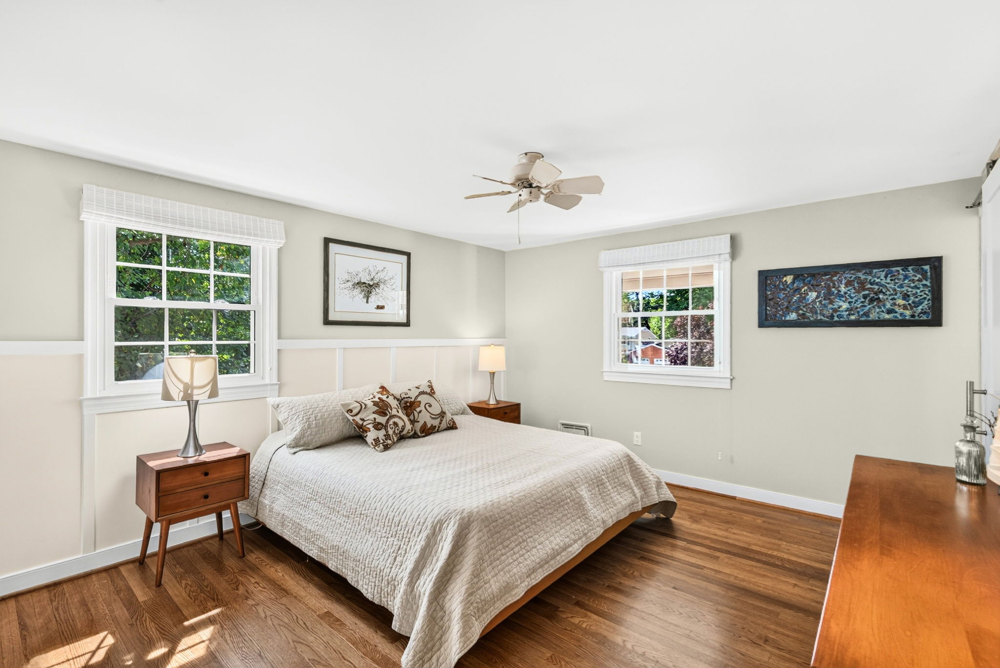 Primary bedroom with recently refinished hardwood floors
