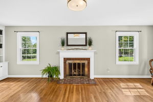 Cozy gas fireplace with mantel and brick surround