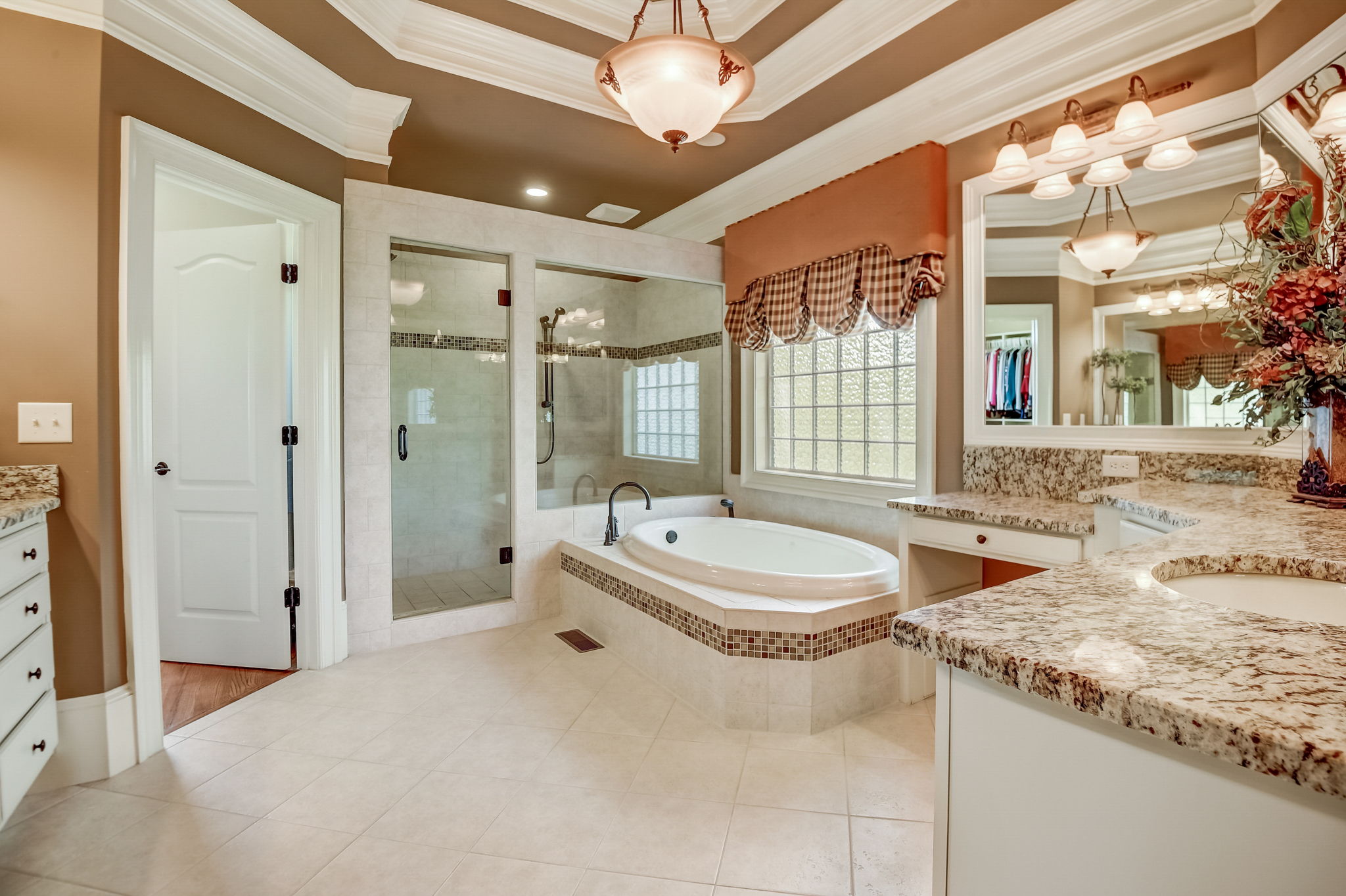 Primary Bathroom with Heated Tile Floors and His and Hers Closets with Built-in's!