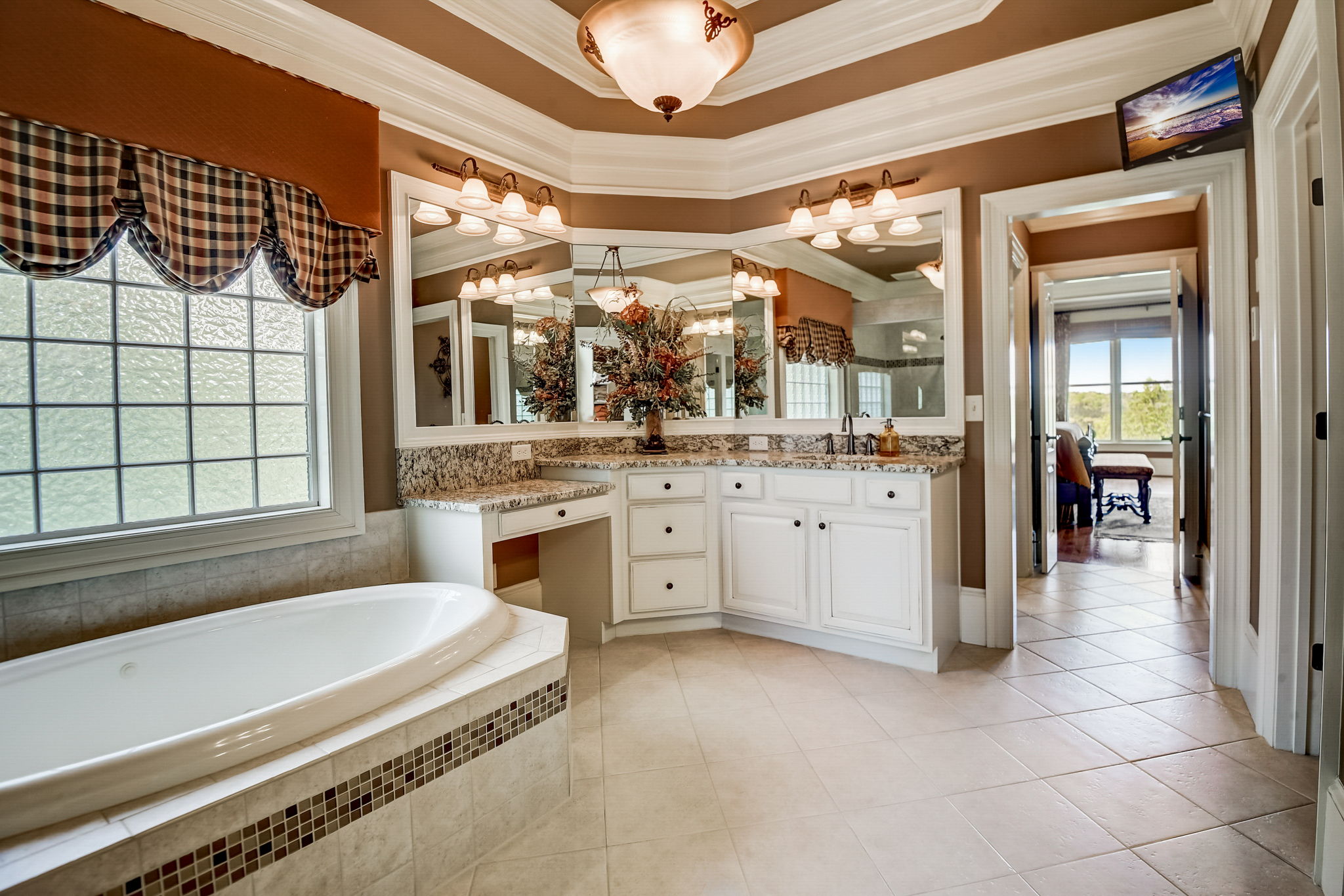 Primary Bathroom with Separate Tiled Shower and Tub, and Double Vanities with Granite Countertops