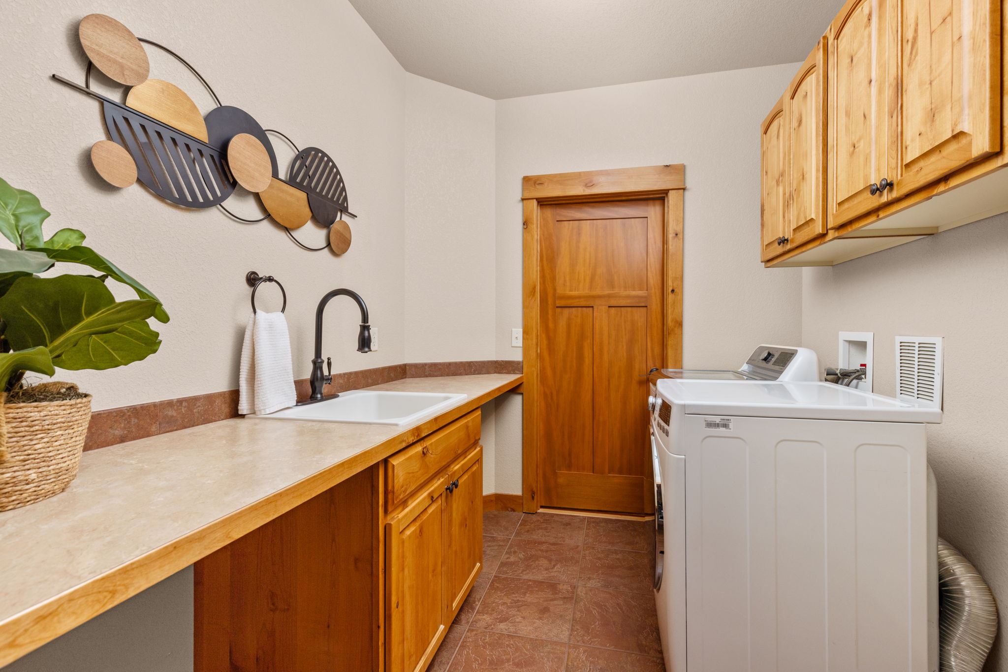 Great Laundry Room with Utility Sink and Counterspace