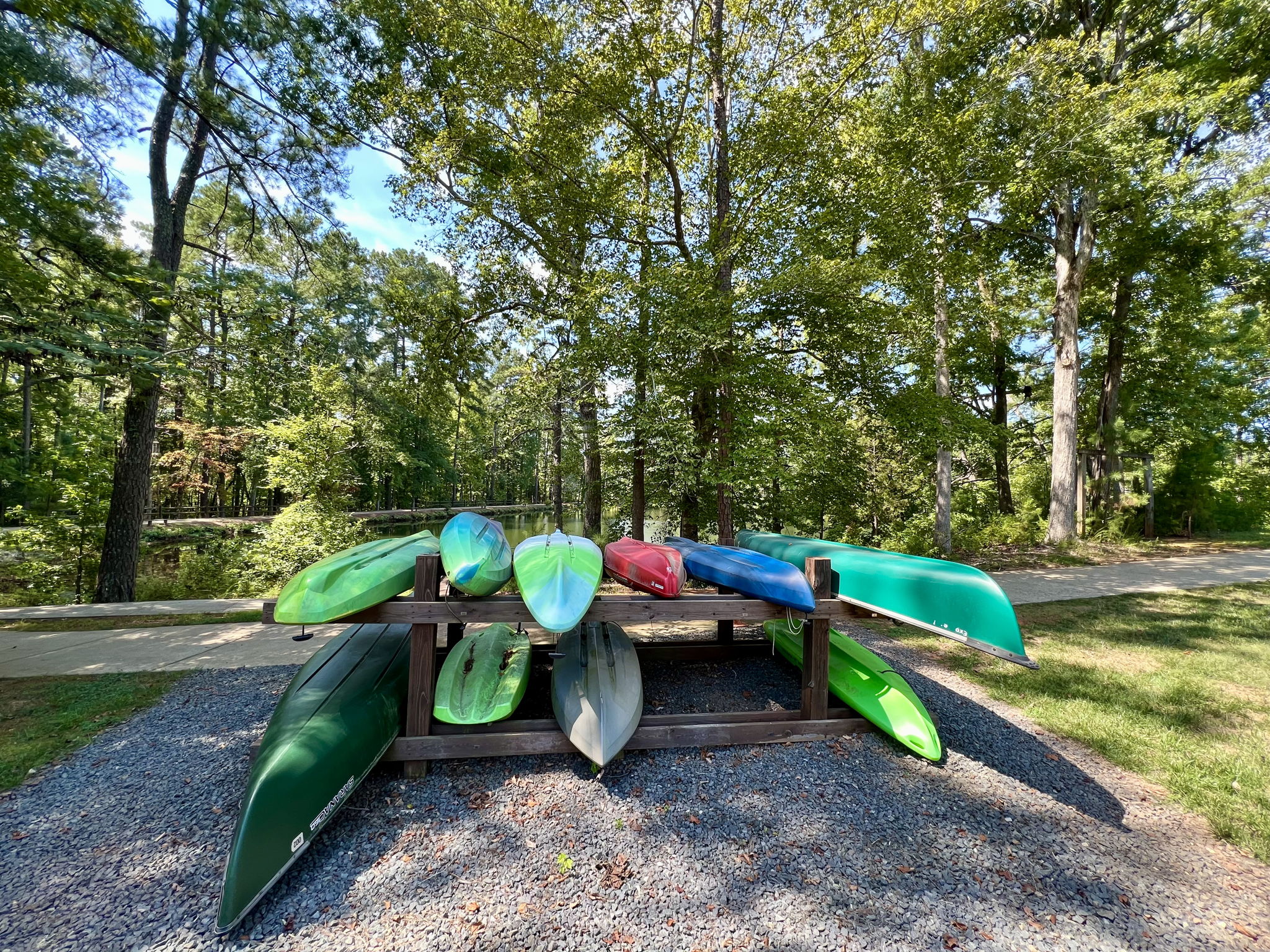 Lake with kayaks and canoes, walking trails, and fishing pier.