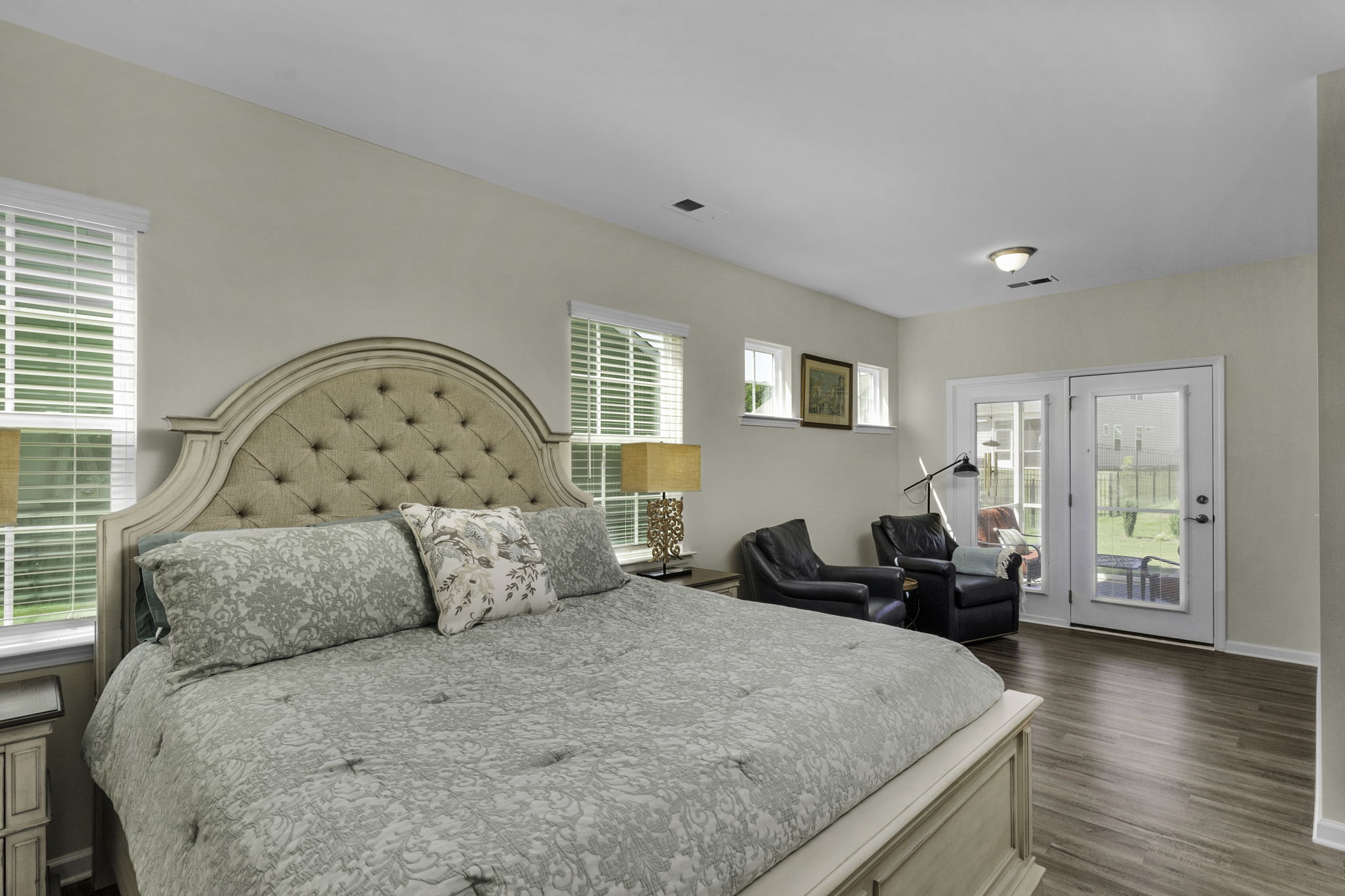 Primary Bedroom with Sitting Area which opens to screened in porch