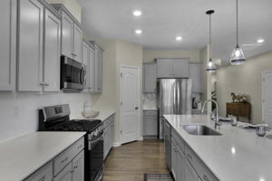 Quartz counters, tile backsplash, walk in pantry.