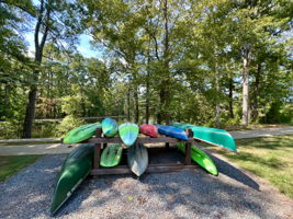 Lake with kayaks and canoes, walking trails, and fishing pier.