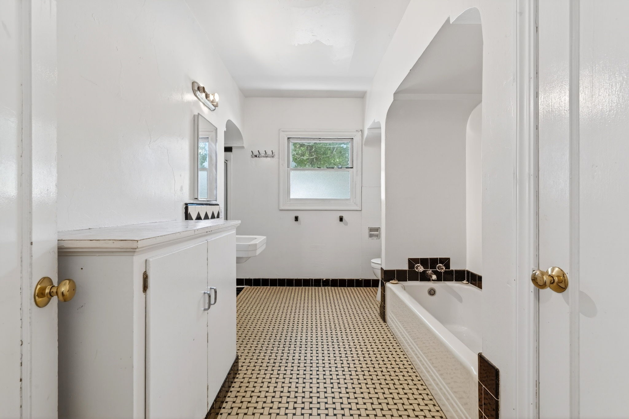 The downstairs bathroom.  There is a bathtub to the right and a shower stall to the left in the background.