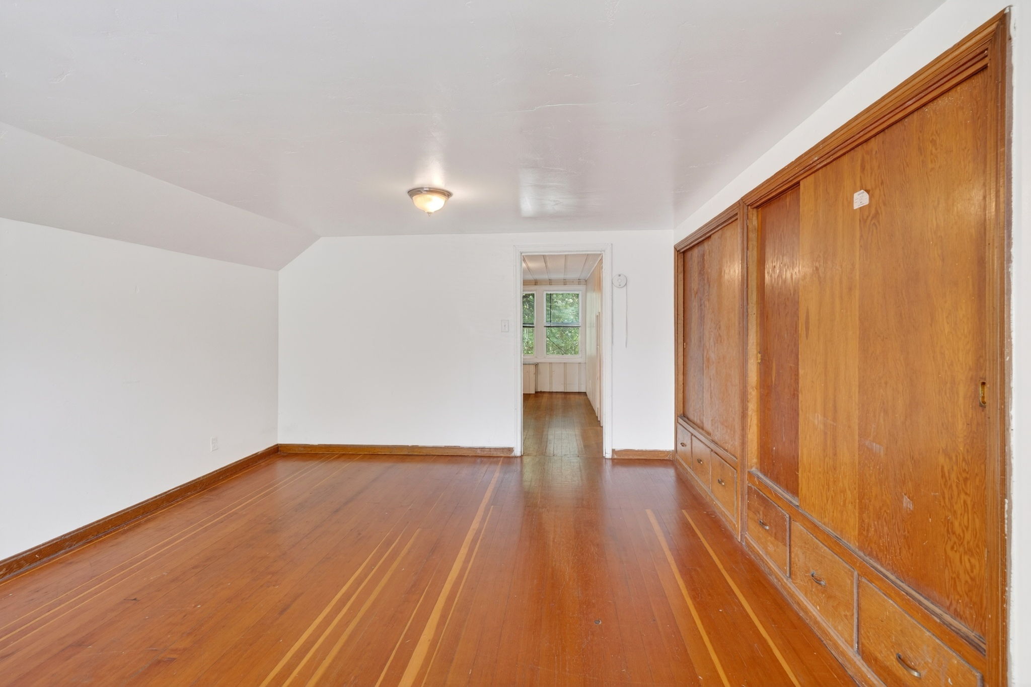 The primary bedroom with built in closets and drawers.  The sitting room is straight forward.