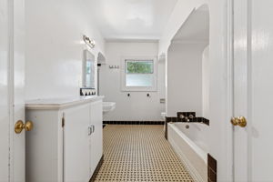 The downstairs bathroom.  There is a bathtub to the right and a shower stall to the left in the background.