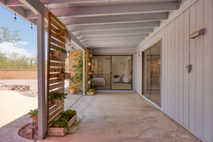 Covered Porch/slider to one of the primary bedrooms