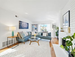 Living Room w/Fireplace + Patio Access